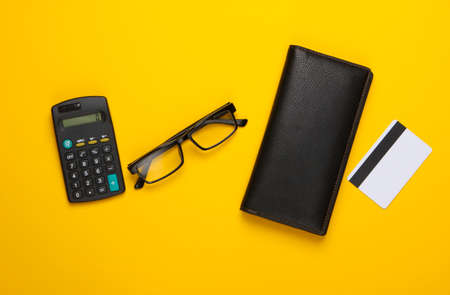 Calculation of the family budget, calculation of expenses. Wallet and bank card, calculator on...