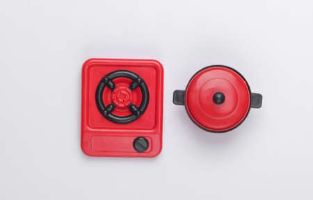 Toy plastic stove with pan on white background. Kid's Kitchen. Top view, minimalismの写真素材