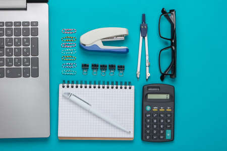 Flat lay composition of office tools, stationery on blue background. Top viewの写真素材