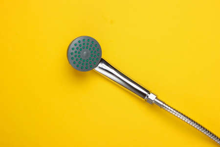 Shower head for the bathroom with hose on yellow background. Top viewの写真素材