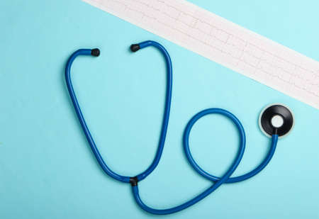 Diagnosis and prevention (treatment) of cardiovascular diseases. Heart cardiogram, stethoscope on a blue background. Healthy heart. Top viewの写真素材