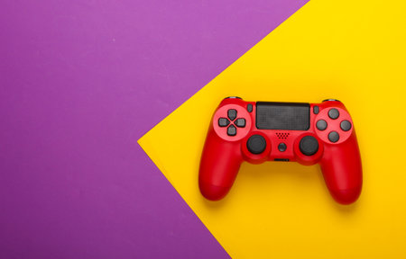 Gamepad on purple yellow background. Gaming, leisure and entertainment concept. Top view