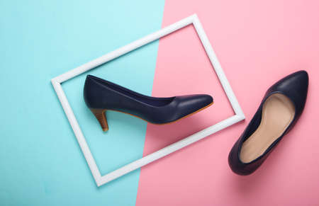 Women's classic high-heeled shoes on blue-pink pastel background with a white frame. Fashion shot. Creative flat lay. Top view. Minimalismの写真素材