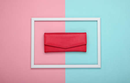 Red leather wallet in a white frame on pink blue background. Top viewの写真素材