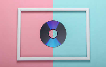 CD disk in white frame on pink blue pastel background. Top viewの写真素材