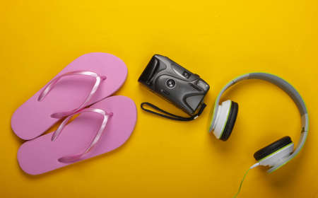 Summer vacation concept, travel. Beach accessories and stuff on a yellow background. Studio shot. Flat layの写真素材