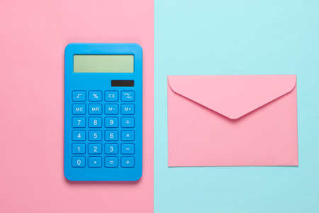 Calculator with envelope on pink blue pastel background. Top view