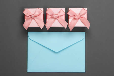 Envelope and gift box on gray background. Top viewの写真素材