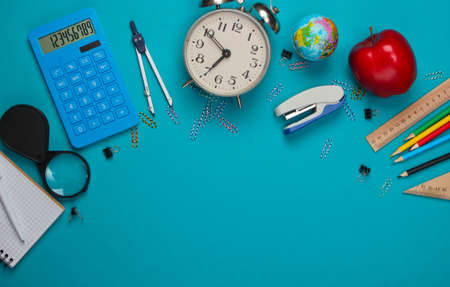 Back to school. School and office supplies on blue background. Educational, study concept. Copy...