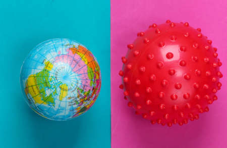 World pandemic covid-19. Globe and virus strain on a blue-pink background. Top viewの写真素材