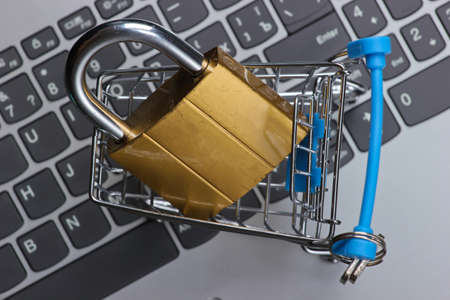 Shopping trolley with lock on keyboard. Hiding and digital protecting information, shoppingの写真素材