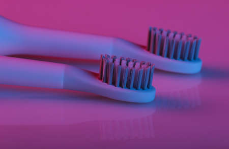 Toothbrush head with pink blue gradient neon lightの写真素材