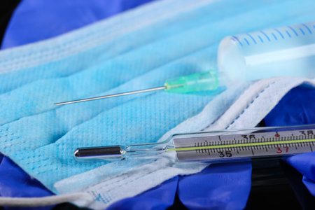 Medical still life. Syringe, thermometer, medical mask with gloves.の写真素材