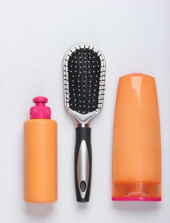 Shampoo bottles, hair conditioner, hair brushes on white background. Hair care. Hygiene. Beauty flat...
