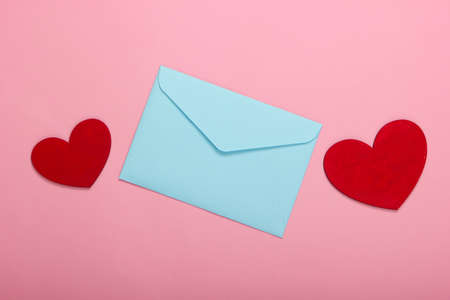Envelope with red hearts (valentines) on pink pastel background. Valentine's Day. Top viewの写真素材