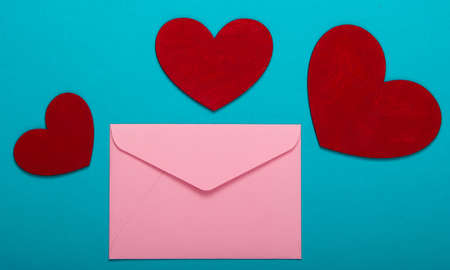 Envelope with red hearts (valentines) on blue background. Valentine's Day. Top viewの写真素材