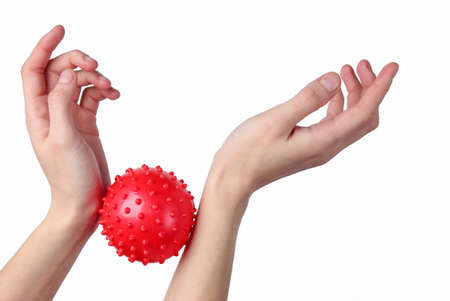 Hands relax with red massage ball on isolated on white background. Antistress toyの写真素材