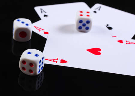 Dice with four aces on a black background.
