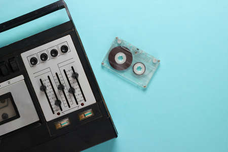 Old audio cassette player. Retro media on a blue background. Top view.