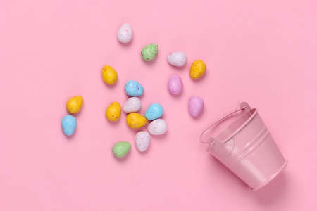 Mini bucket with easter eggs on a pink pastel background. Easter minimalism. Pastel color trendの写真素材