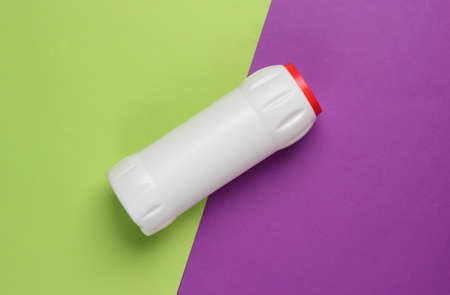 Bottle of cleaning product on purple green background. top view. cleaning concept. minimalism