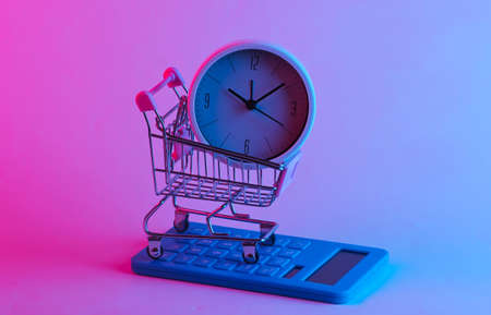 Shopping time. Supermarket trolley with calculator, clock in trendy neon light. Gradient pink-blue glow. Concept art. Minimalismの写真素材