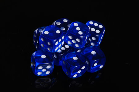 Blue dice on a black background. Game addiction. Luck