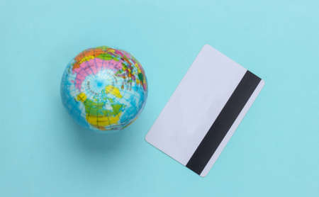 Globe with a credit card on a blue background. Top viewの写真素材