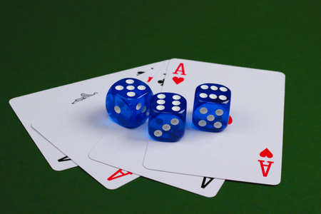Four aces with dice on a green background. Casino