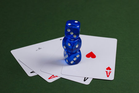 Four aces with dice on a green background. Casino