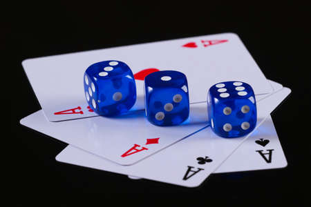 Four aces with dice on a black background.の写真素材