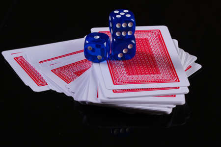 Playing cards with dice on a black background. Poker casino, gambling addictionの写真素材