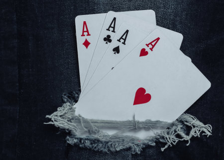Four aces in a torn hole jeans