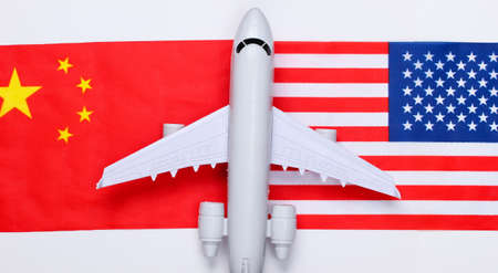Air flight between countries. Figurine of airplane with the flag of China and the USA. Air travelの写真素材