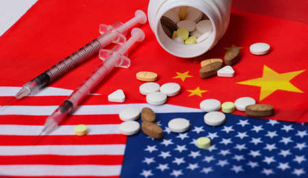 Flags of the USA, China with syringes and pills. Vaccination, covid-19の写真素材