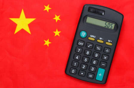 Calculator on flag of China. Crisisの写真素材