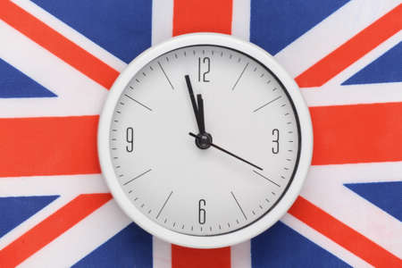 White clock on background of Great Britain flag