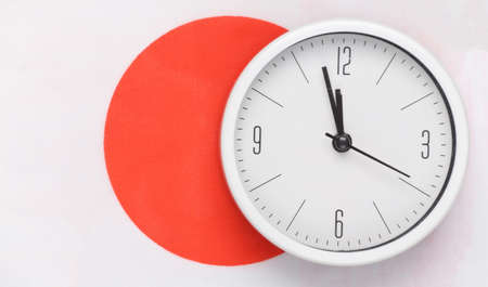 White clock on background of Japanese flagの写真素材