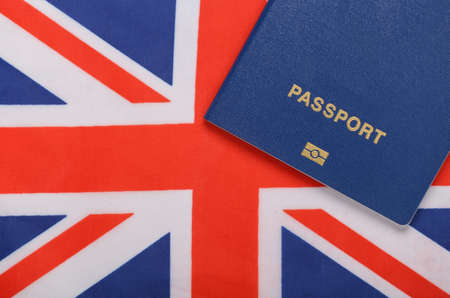 Travel concept. Passport against the background of the British flagの写真素材