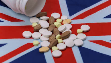 Bottle of pills with British flagの写真素材