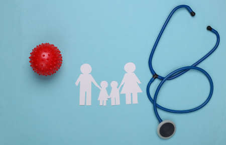 Paper family together stethoscope and model strain of virus on a blue background.の写真素材
