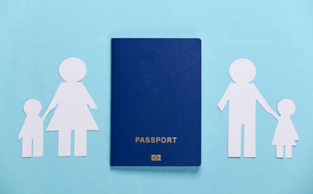 Broken family, divorce. Split paper family, passport on blue background