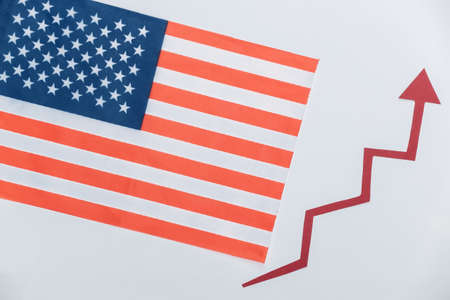 USA flag with a red growth arrow. Arrow graph going up. The economic growthの写真素材