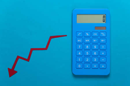 Calculator and red Fall arrow. Fall graph going down. Economic recession, crisisの写真素材