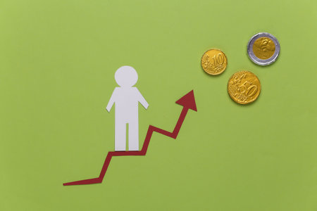 Paper man on growth arrow, coins. Green background. Symbol of financial and social success, stairway to progress. Career ladder.の写真素材
