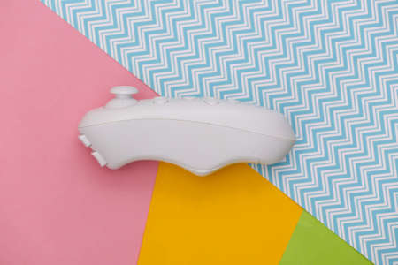 Modern joystick on colored background. flat lay. top view