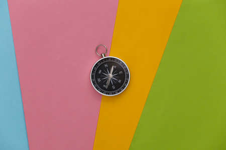 Compass on colored background. Travel, adventure flat lay. top viewの写真素材