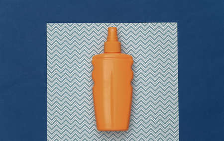 beach holidays. Sunblock bottle, starfish on blue background. top view. flat lay