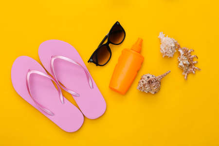 Beach rest accessories top view on yellow bakgroundの写真素材