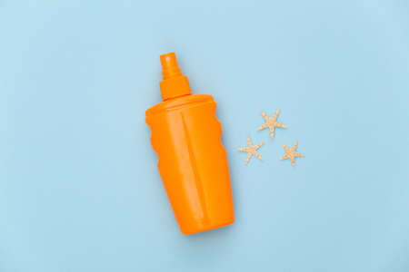 beach holidays. Sunblock bottle, starfish on blue background. top view. flat layの写真素材